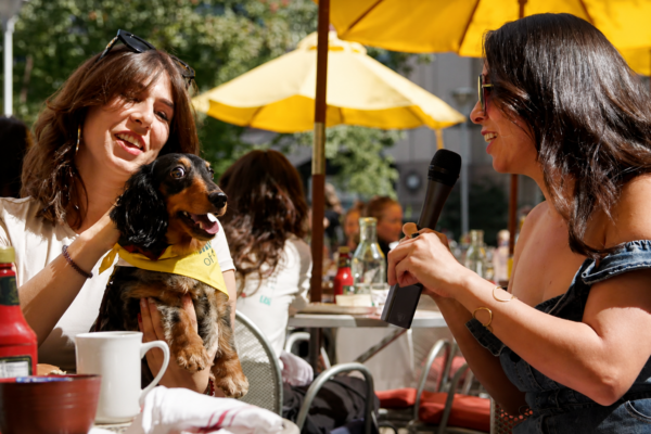 women eating at restaurant with dog